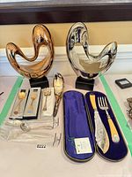 Overall lot showing two sculptures and flatware pieces