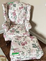 Front view of floral wingback chair with ottoman
