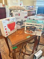 Boxed Lékué popcorn maker, EatSmart NutritionPro scale, Hamilton Beach egg bites maker on table