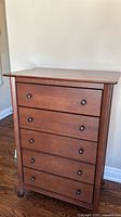 Front view of dresser showing six drawers and knobs