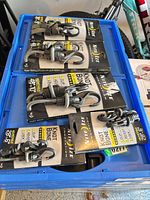 Six Nite Ize KnotBone bungee cords on collapsed blue bins