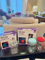 Two boxed Outward Hound toys and three glass canister jars displayed together