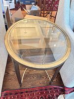 Full view of oval glass top side table between chairs