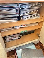 Cabinet showing multiple albums stacked on shelves