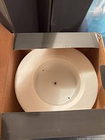 Open box showing top of ivory flameless LED candle