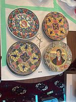 Top-down of four plates showing two motif styles and one portrait style