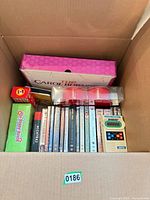 Open box showing The Carol Burnett Show set, multiple DVD spines, red and green game boxes