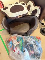 Dog sofa, two cushions and bag of toys overview
