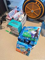 Stack of Ziploc boxes, Space Saver packs in box, fan in background
