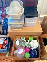 overview of stacked storage containers, bowl, tall container, box of bottles