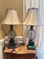 Full view of both lamps on table showing shades, bodies, bases and cords