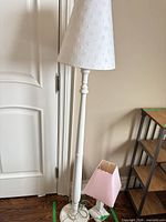 Full view of floor lamp, table lamp shade at base