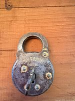 Front view of padlock showing brand and key inserted