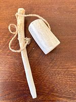 Full view of bone cylinder, stick, and connecting cord