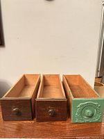 Front view showing three drawers side by side