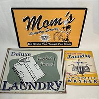 All three metal laundry-themed plaques displayed together