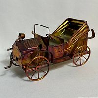 Right side view of tin coach car showing patina and overall form