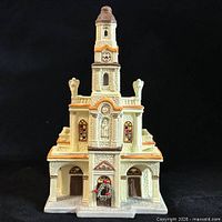 Front view of porcelain church showing doors, wreath and tower