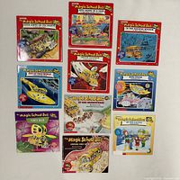 Front covers of all eight Magic School Bus paperback books laid out for identification