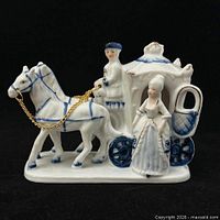 Front view showing two horses, coachman, lady and carriage