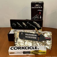 Full lot showing wine accessory box open with tools, insulated sequined wine bag, and Corkcicle chiller in packaging