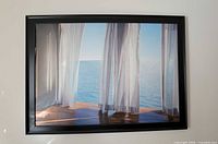 Full view of framed ocean window picture on wall