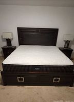 Full view of king bed frame with headboard, mattress and two drawer footboard
