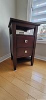 Front angled view showing drawers, legs and finish