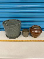 Front view of all three ceramic pots with ruler for scale