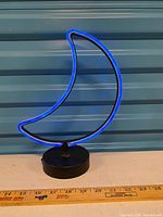 Lamp unlit beside ruler showing height