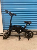 Full left-side view of entire mini bike showing frame, wheels, saddle, and kickstand