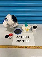 All items laid out including projector, stand, discs, lens cover, night light and camera