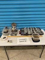 Overall view of lot on table: three clear totes, organizer case, plastic container