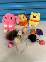 All eleven plush items, keychains and headband displayed together