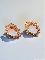 front view of both opal stud earrings showing filigree settings