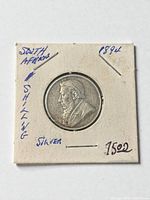 Obverse of 1894 South African Shilling showing Paul Kruger bust in cardboard flip