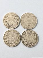 Four Canadian silver quarters reverse side showing denomination and dates 1916, 1917, 1918, 1918