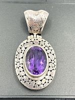 Front view showing amethyst, textured frame and bail