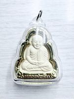 Front view of Buddha pendant in clear case