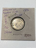 Coin in 2x2 holder front view showing handwritten notes