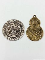 Front view of both pendants showing primary designs