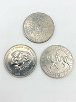 Three commemorative crowns obverse sides visible