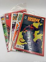 Front view showing Hellboy #1 and stack of comics in plastic sleeve