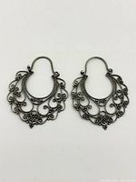 Front view of both sterling silver filigree earrings showing full design