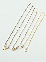 All three gold-filled pocket watch chains laid out