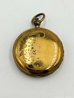 Front view showing engraved floral motif and bale