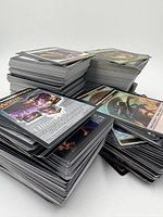 Multiple large stacks of Magic: The Gathering cards