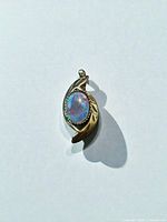 Front view of pendant showing opal and leaf design