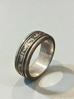 Ring upright showing footprint motif on outer band