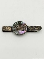 Front view showing abalone inlay and silver motif